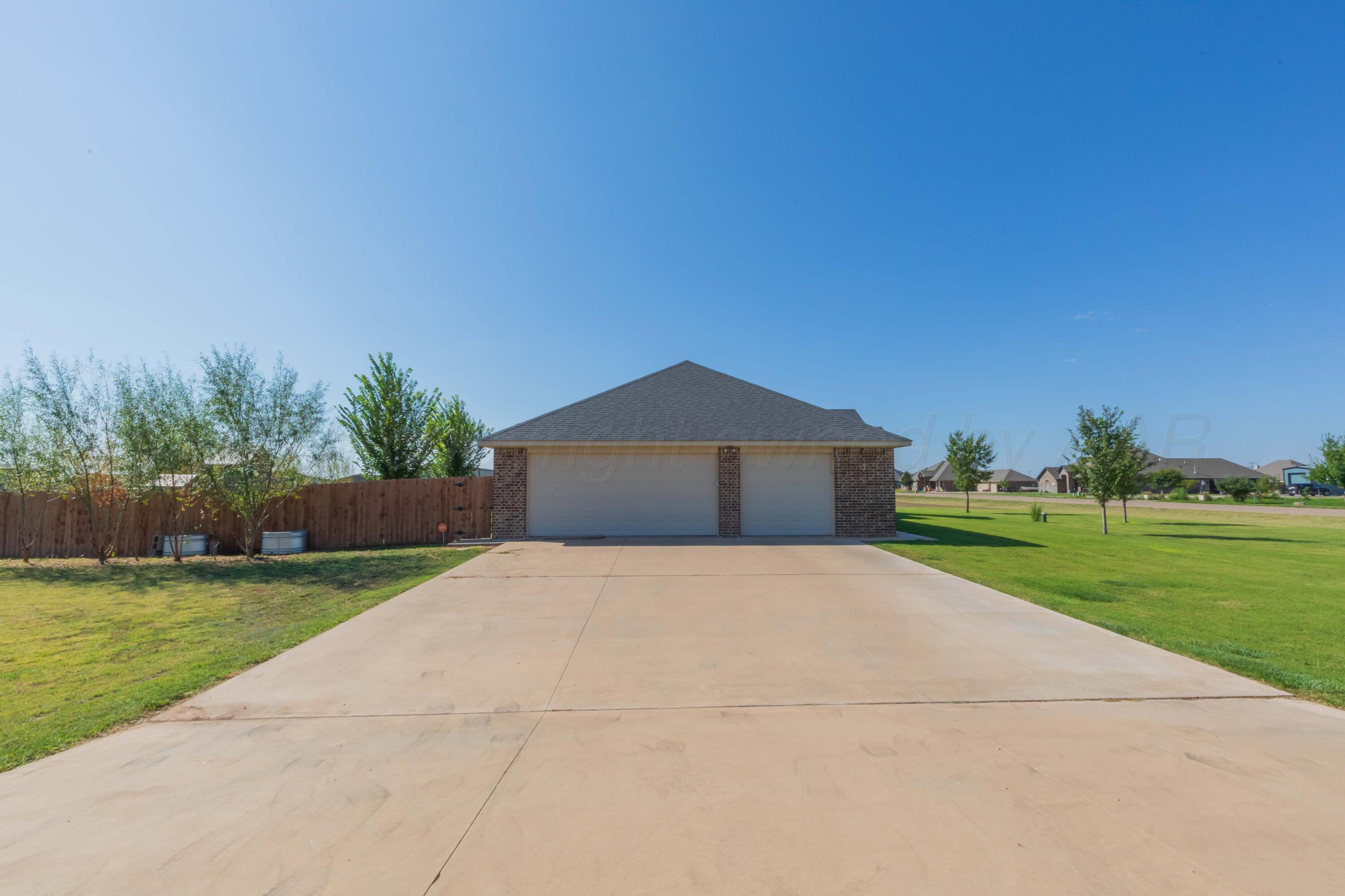 9801 Yesterday Amarillo, TX 79119 - Photo 18 of 54 a big yard with large trees and plants