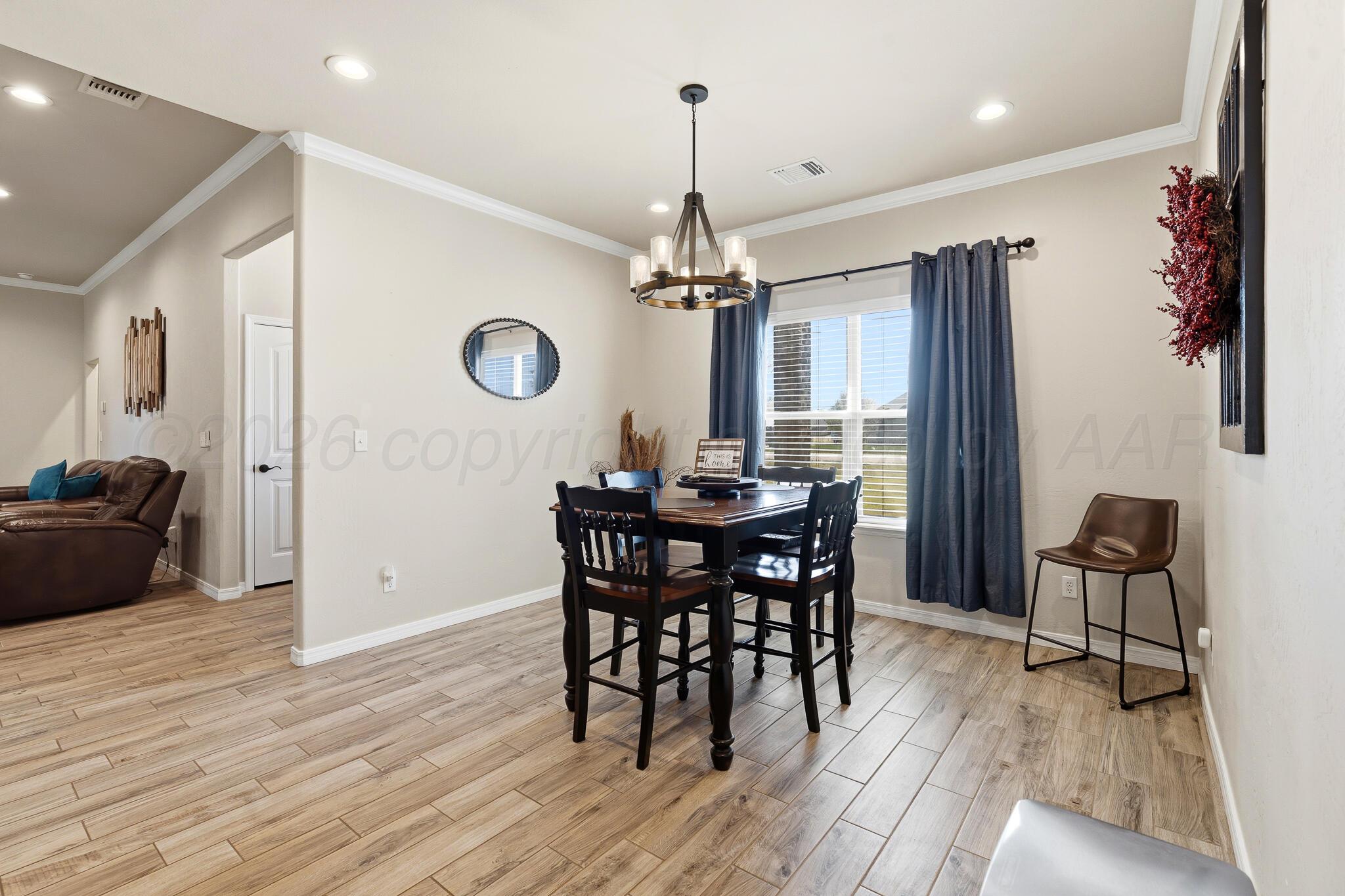 9801 Yesterday Amarillo, TX 79119 - Photo 20 of 54 a view of a dining room with furniture window and wooden floor