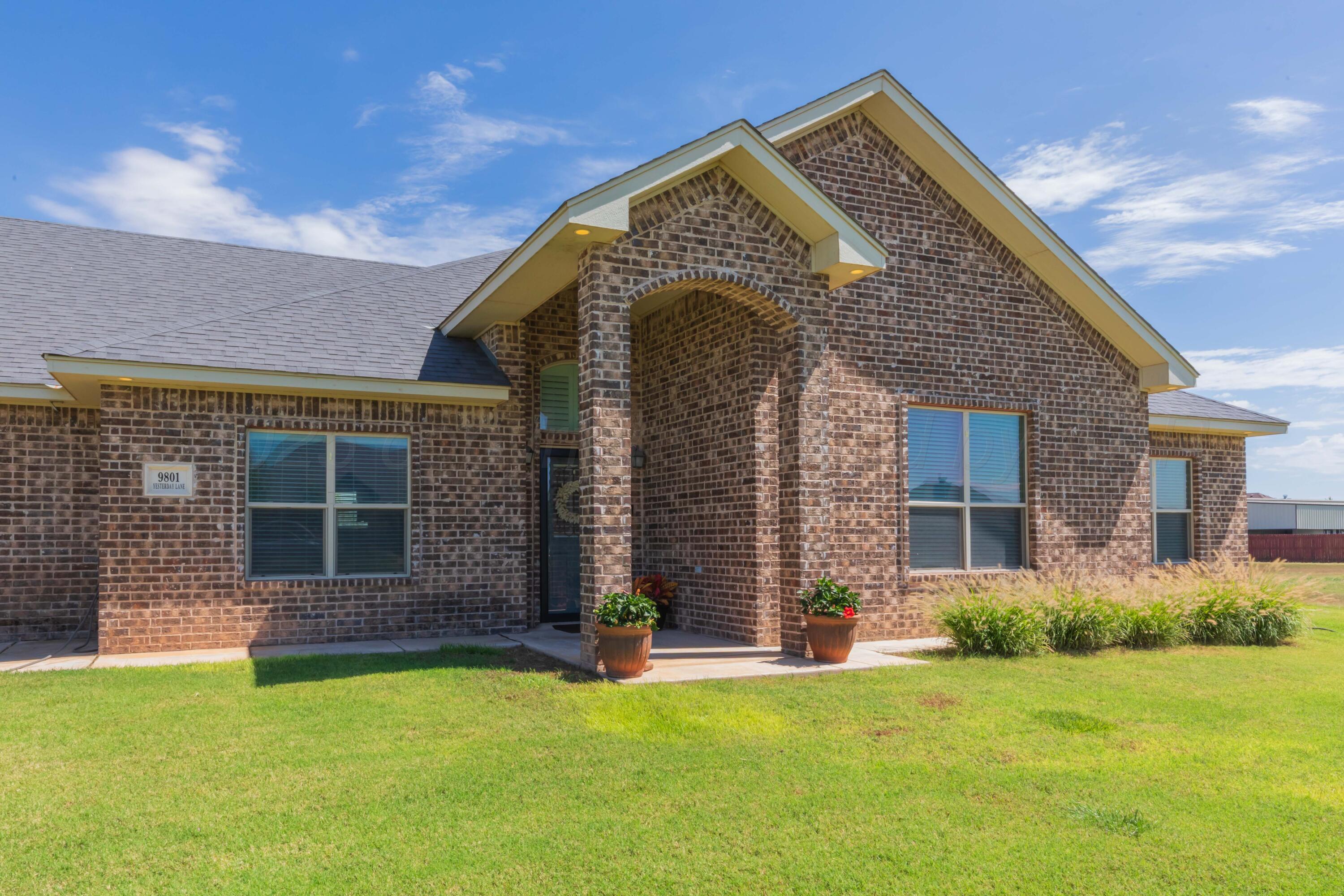 9801 Yesterday Amarillo, TX 79119 - Photo 2 of 54 a front view of a house with a yard