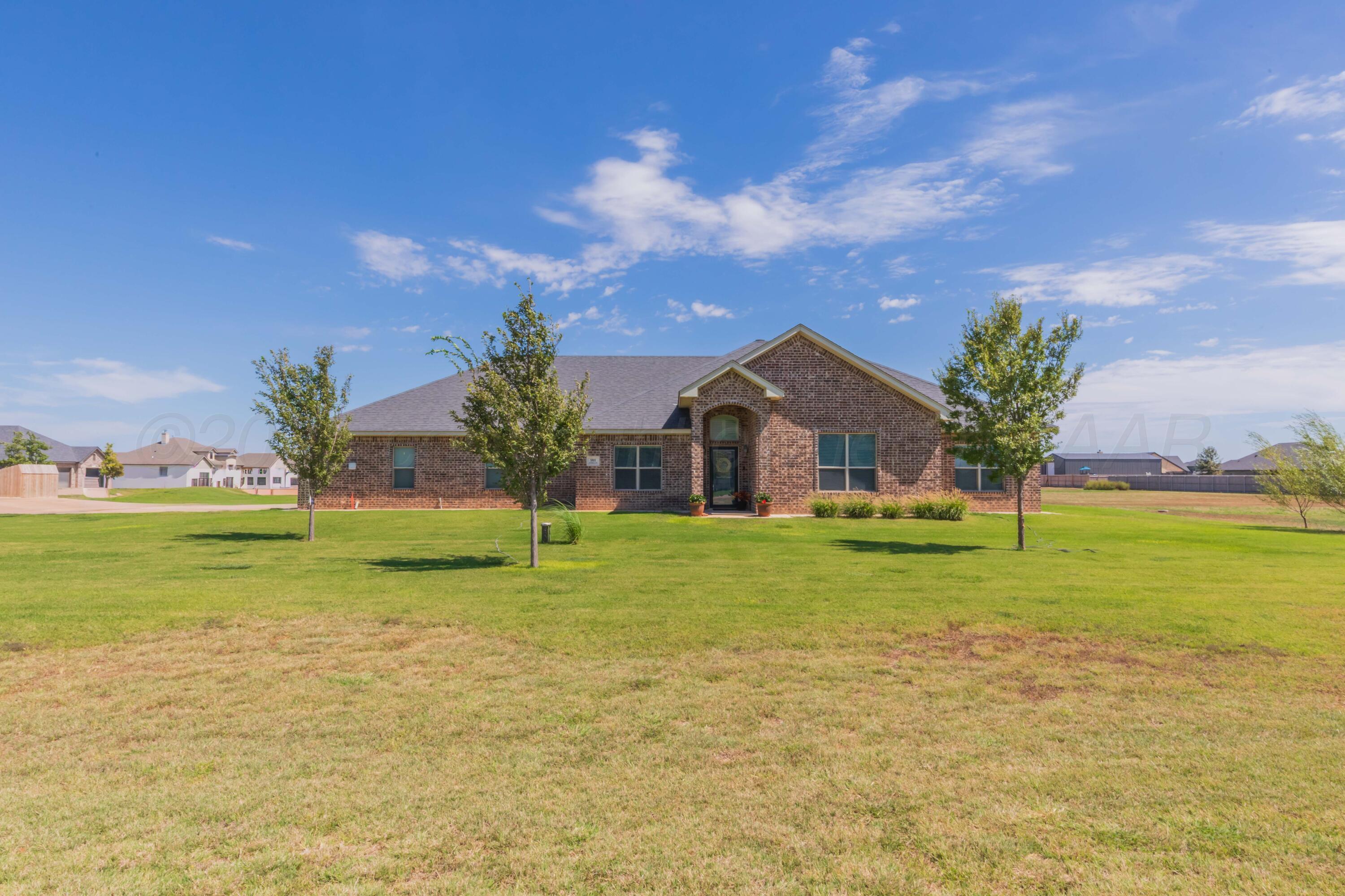 9801 Yesterday Amarillo, TX 79119 - Photo 3 of 54 a front view of a house with a yard