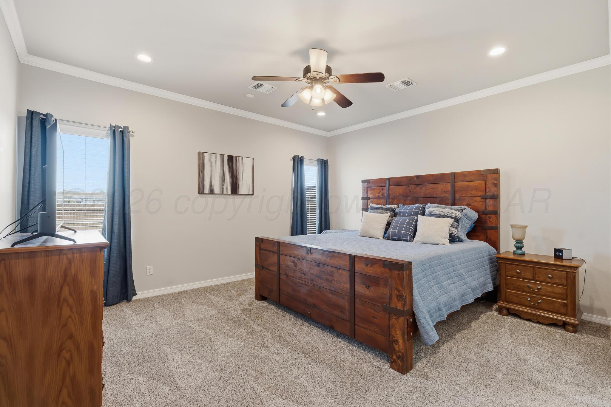 9801 Yesterday Amarillo, TX 79119 - Photo 34 of 54 a bedroom with a bed and a chandelier