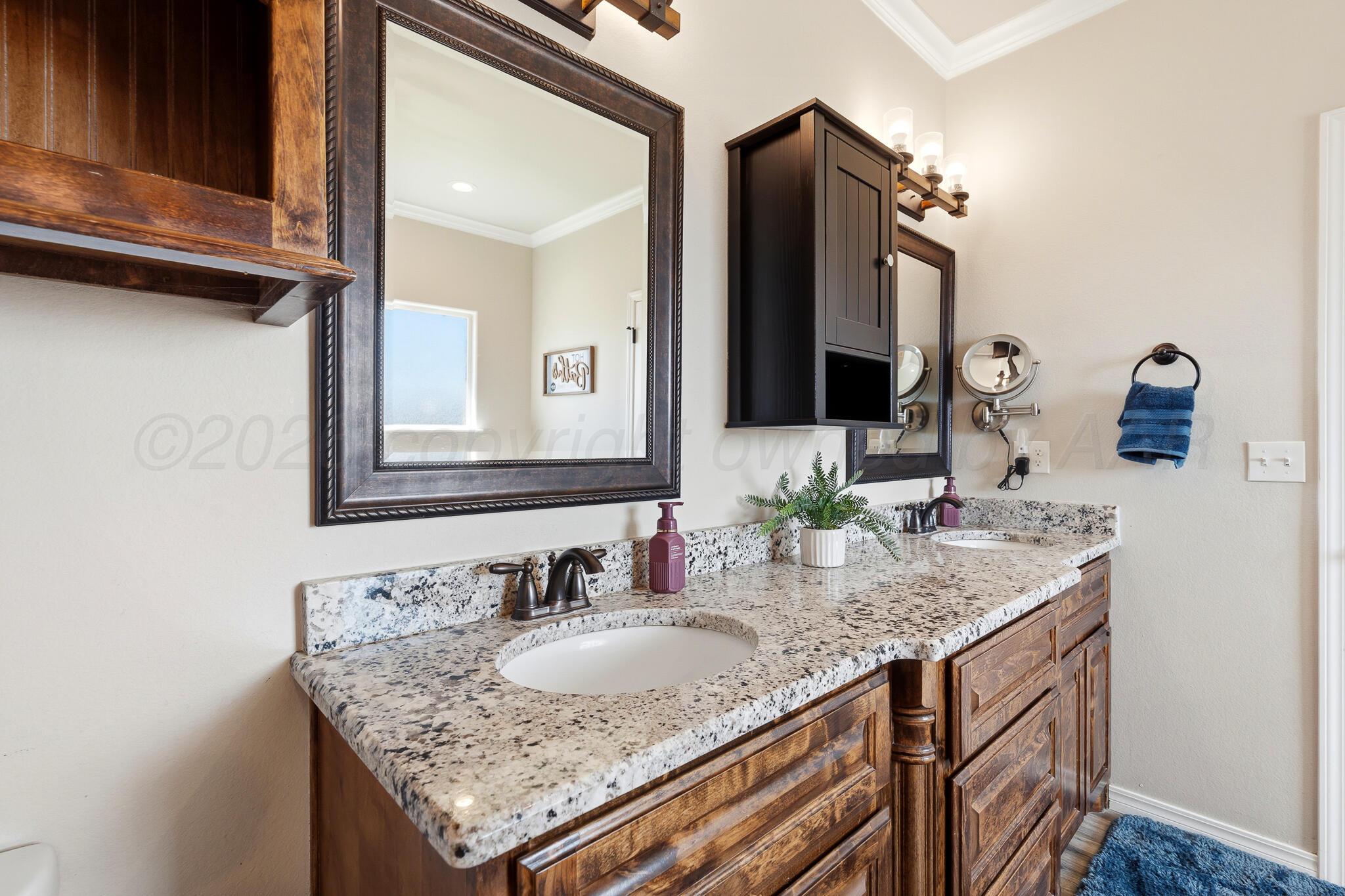 9801 Yesterday Amarillo, TX 79119 - Photo 35 of 54 a bathroom with a granite countertop sink and a mirror