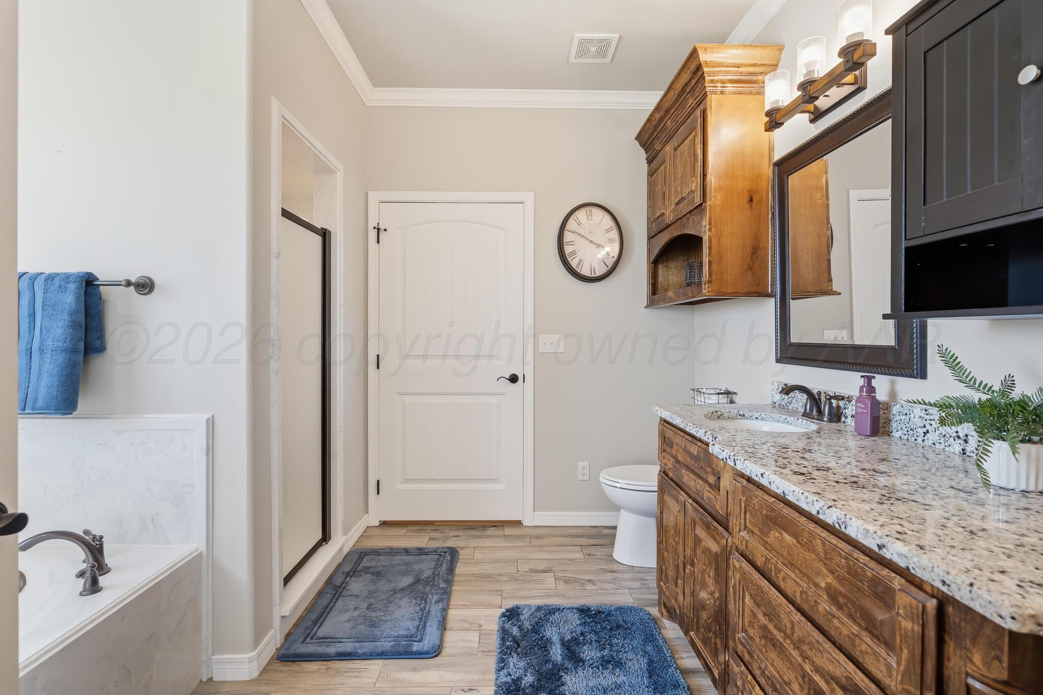 9801 Yesterday Amarillo, TX 79119 - Photo 37 of 54 a bathroom with a granite countertop sink and a mirror
