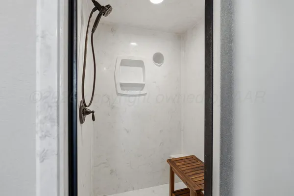a bathroom with a granite countertop sink mirror and a bathtub