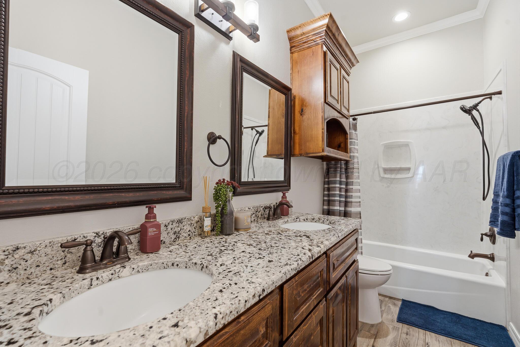 9801 Yesterday Amarillo, TX 79119 - Photo 42 of 54 a bathroom with a granite countertop sink mirror and a bathtub