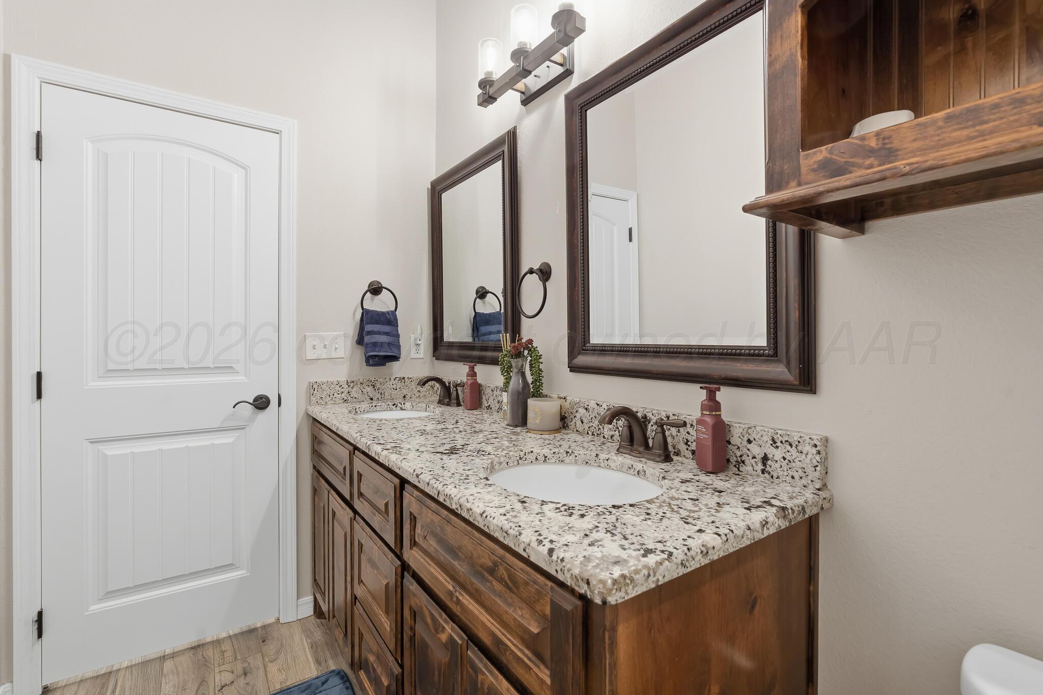 9801 Yesterday Amarillo, TX 79119 - Photo 43 of 54 a bathroom with a granite countertop sink and a mirror