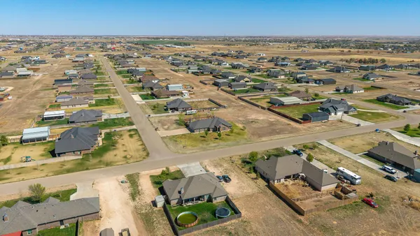 an aerial view of residential houses with outdoor space
