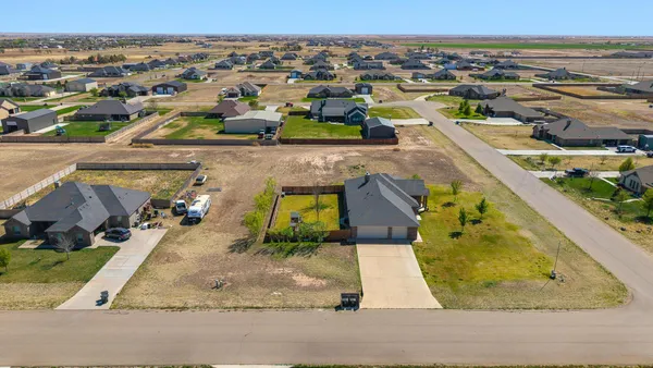 an aerial view of residential houses with outdoor space