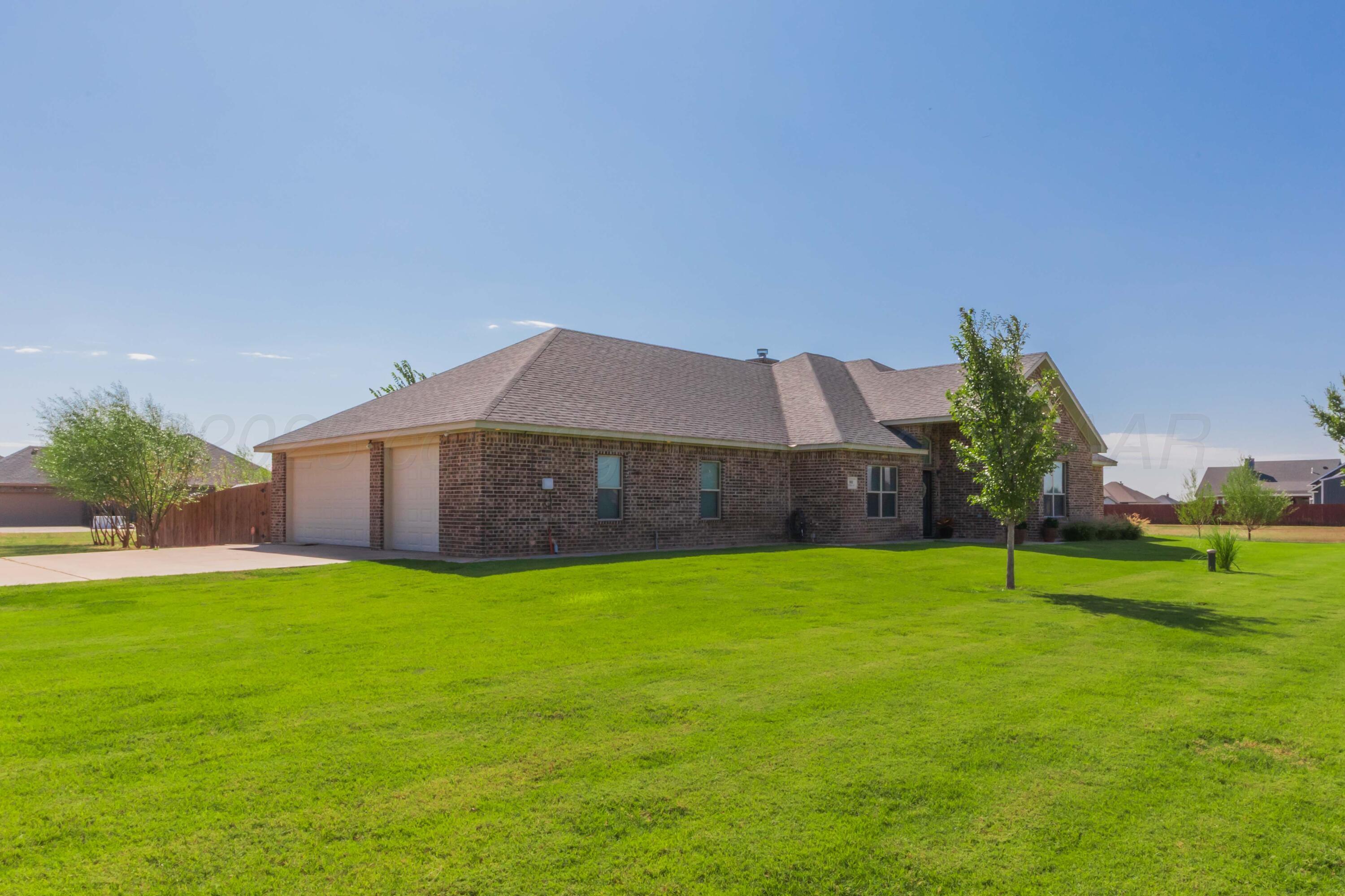 9801 Yesterday Amarillo, TX 79119 - Photo 5 of 54 a house that is sitting in the grass with large trees