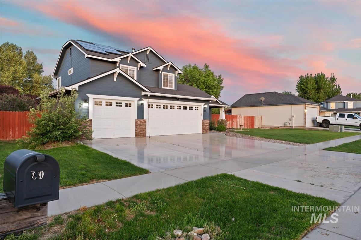 80 Cobblestone Court Middleton, ID 83644 - Photo 33 of 48 Two-story residential exterior featuring dark siding, stone accents, and white trim