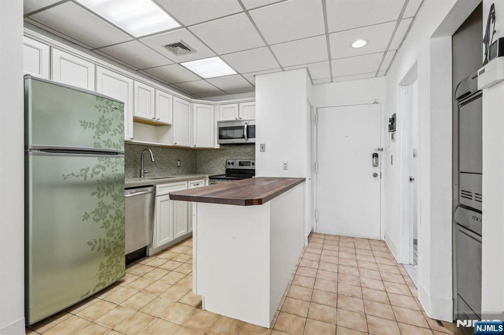 279 Clark Street, Unit A7 Hackensack, NJ 07601 - Photo 14 of 34 a kitchen with stainless steel appliances granite countertop a refrigerator and a stove
