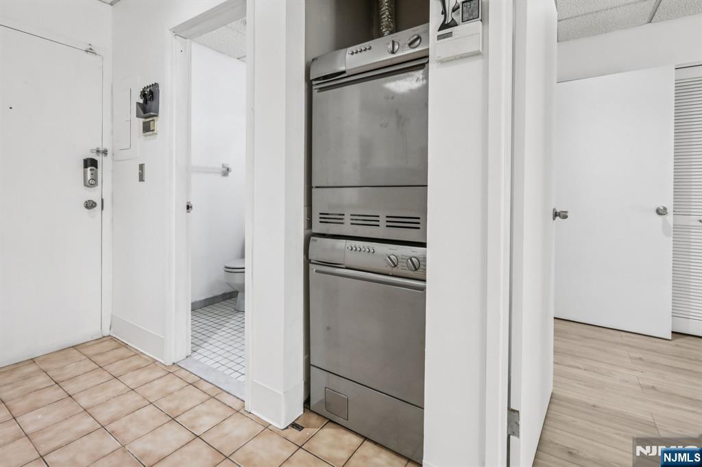 279 Clark Street, Unit A7 Hackensack, NJ 07601 - Photo 20 of 34 a kitchen with a refrigerator and cabinets