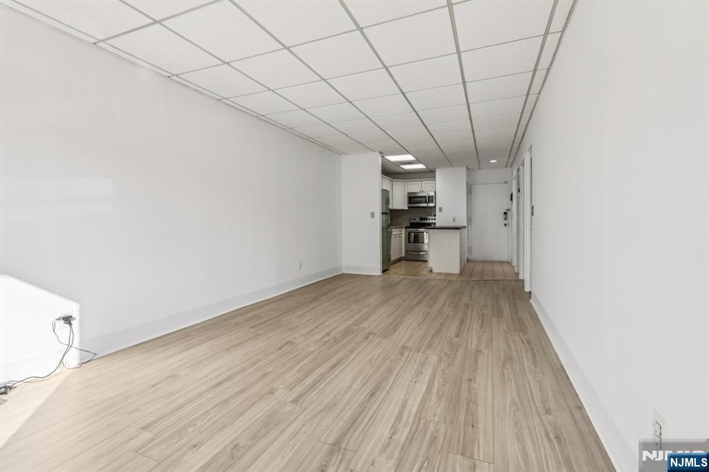 279 Clark Street, Unit A7 Hackensack, NJ 07601 - Photo 2 of 34 a view of a kitchen with a wooden floor and a sink