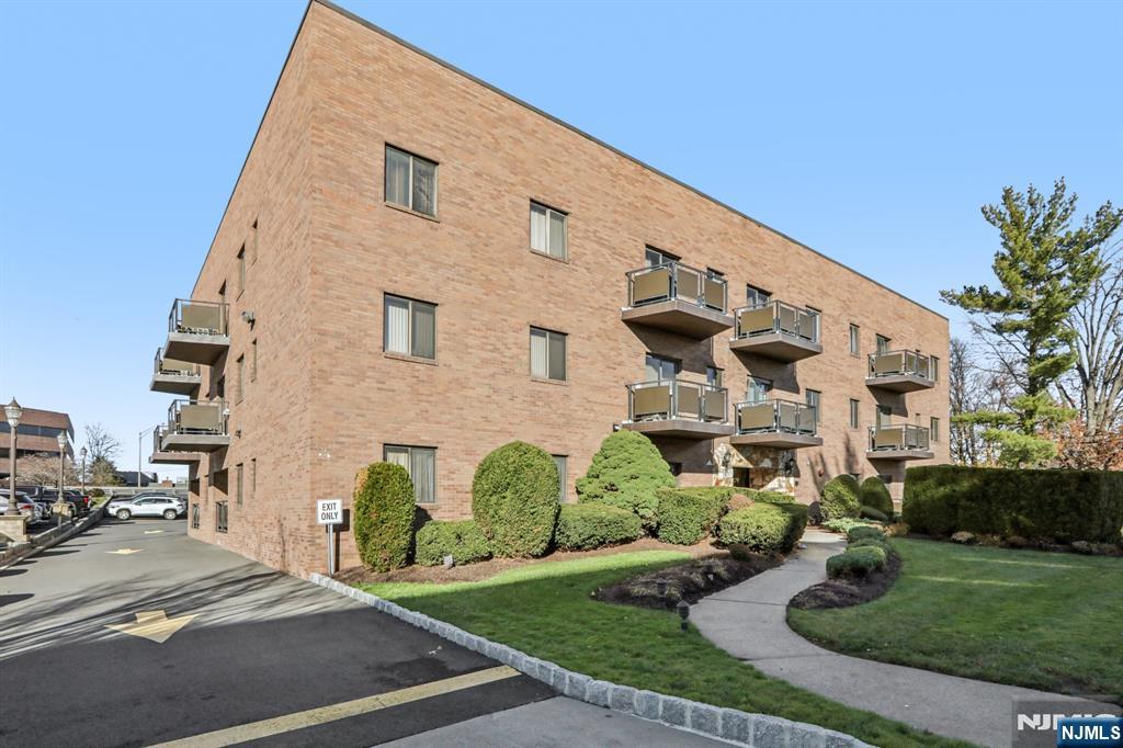 279 Clark Street, Unit A7 Hackensack, NJ 07601 - Photo 31 of 34 a front view of a house with garden
