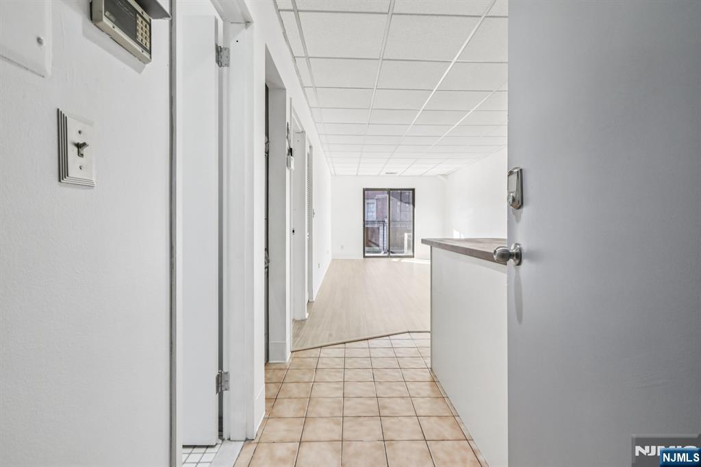 279 Clark Street, Unit A7 Hackensack, NJ 07601 - Photo 7 of 34 a view of a hallway with a white walls and a white door