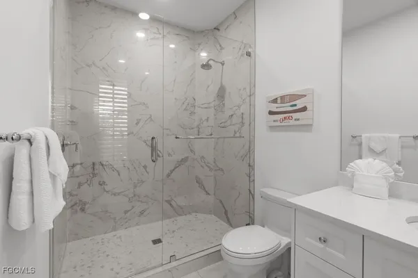 a bathroom with a shower a toilet a sink and a shower