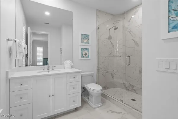 a bathroom with a double vanity sink toilet and shower