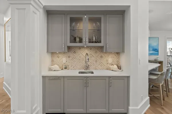 a view of a kitchen with white cabinets