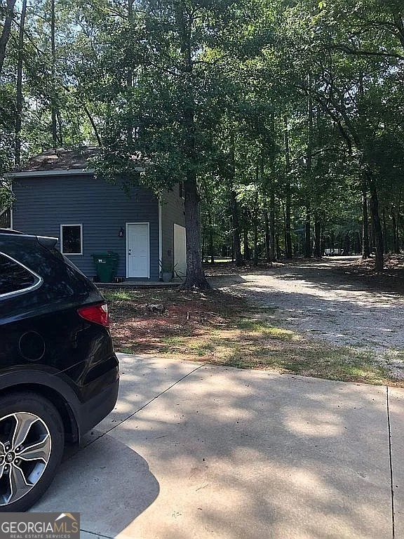 135 Southshore Road Eatonton, GA 31024 - Photo 2 of 13 a car parked in front of a house