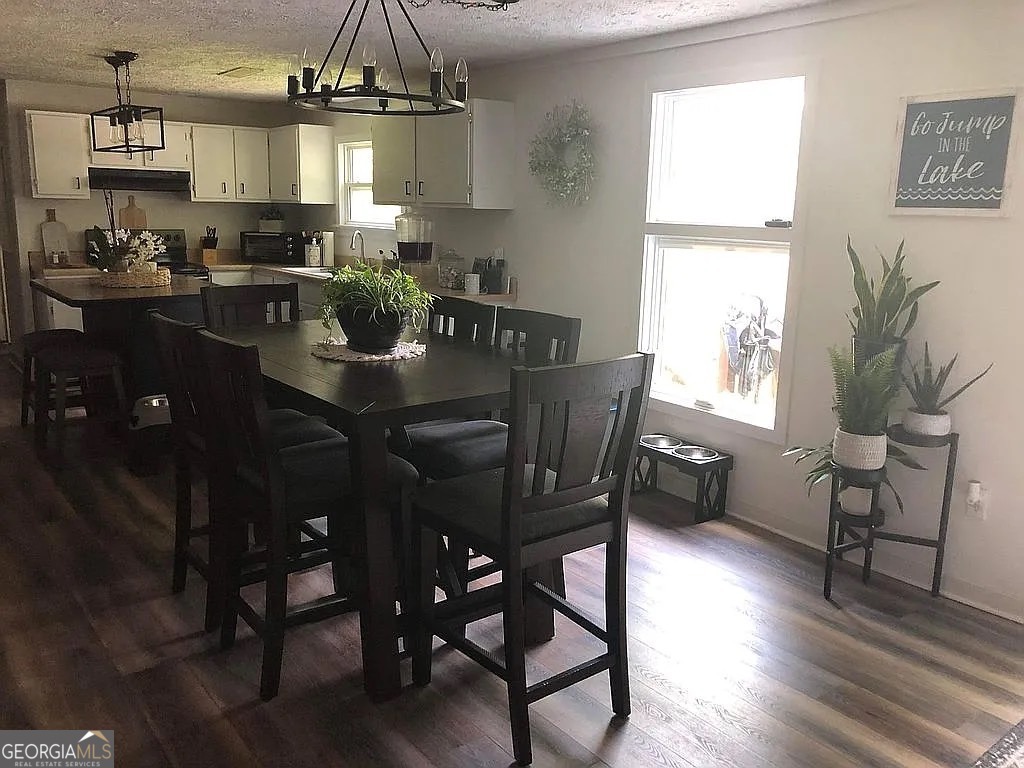 135 Southshore Road Eatonton, GA 31024 - Photo 6 of 13 a view of a dining room with furniture window and wooden floor