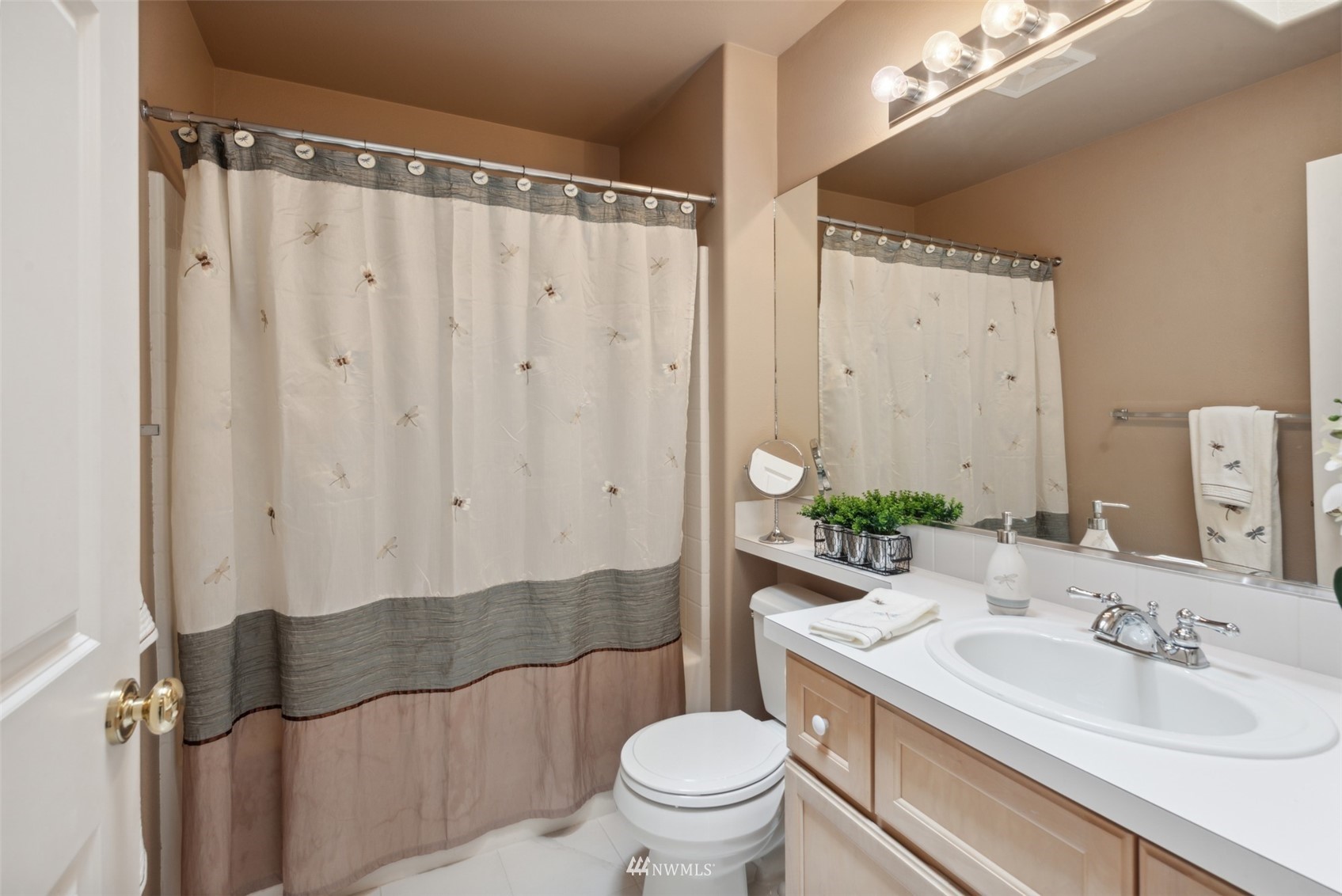 562 Chelan Place Northeast Renton, WA 98059 - Photo 18 of 27 a bathroom with a sink a toilet and shower curtain
