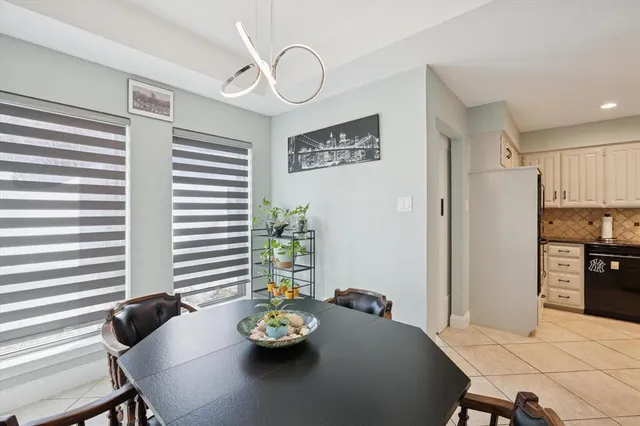 a view of a dining room with furniture and a window