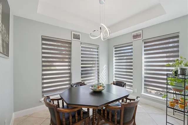 a view of a dining room with furniture and a potted plant