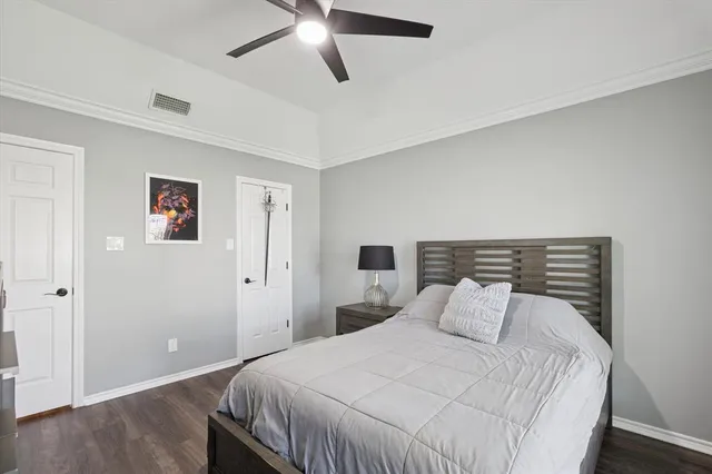 a bedroom with a bed and a painting on the wall