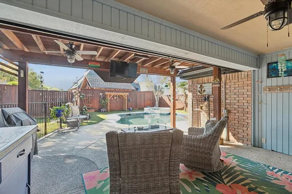 a dining room with furniture and a floor to ceiling window