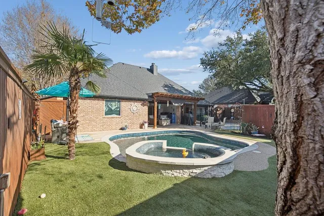 a house view with swimming pool and porch
