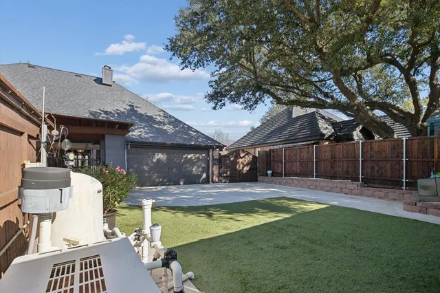 a view of a backyard with plants and patio