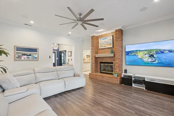 a living room with furniture wooden floor and a fireplace