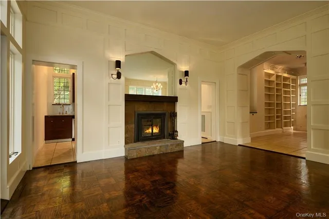 a view of a livingroom with wooden floor and a fireplace