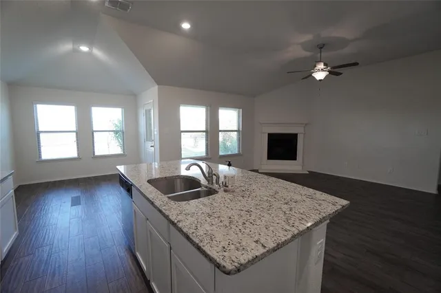 a living room with granite countertop furniture and a fireplace