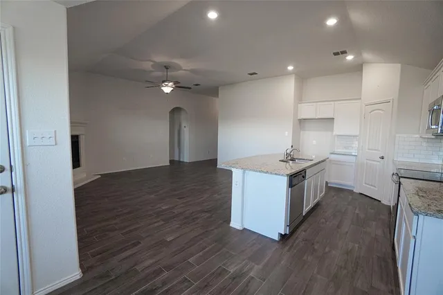 a kitchen with sink cabinets and wooden floor
