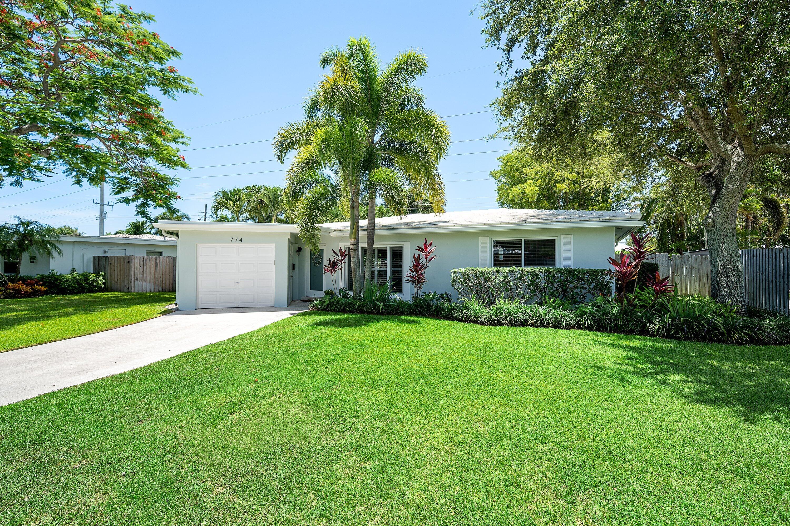 774 Southwest 7th Street Boca Raton, FL 33486 - Photo 1 of 28 a front view of house with yard and green space