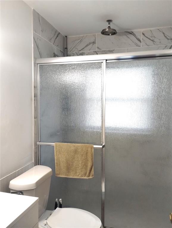 417 East Main Street Dundee, FL 33838 - Photo 14 of 24 a white toilet sitting next to a bathroom sink