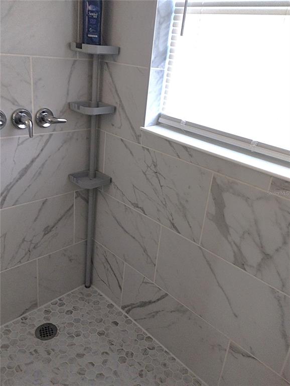 417 East Main Street Dundee, FL 33838 - Photo 15 of 24 a bathroom with a shower