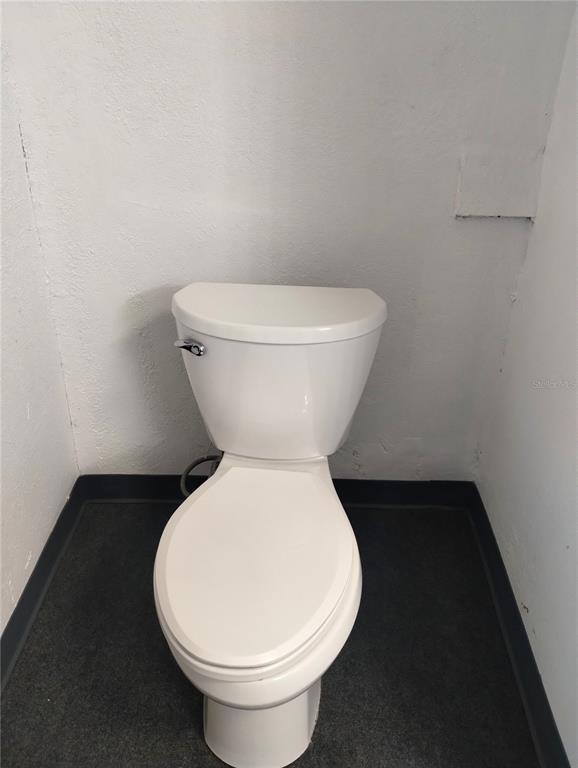 417 East Main Street Dundee, FL 33838 - Photo 18 of 24 a white toilet sitting next to a white wall