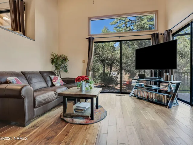a living room with furniture and kitchen view