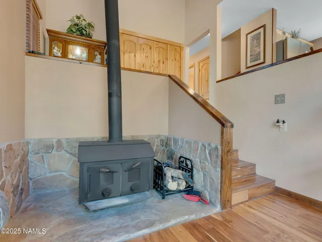 a kitchen with stainless steel appliances granite countertop a stove a sink dishwasher a dining table and chairs with wooden floor