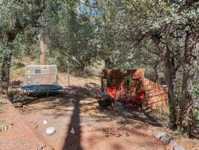 a view of a backyard with table and chairs