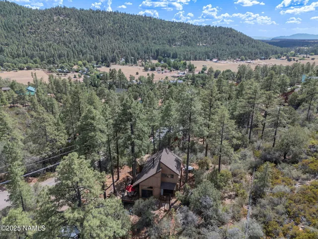 a view of a house with a yard covered in snow