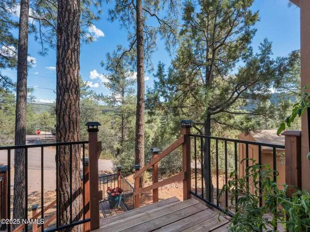 a view of a patio with table and chairs and potted plants