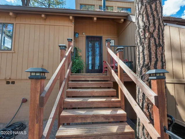 a hallway with painting and a potted plant