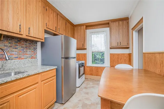 a kitchen with stainless steel appliances granite countertop a refrigerator sink and cabinets