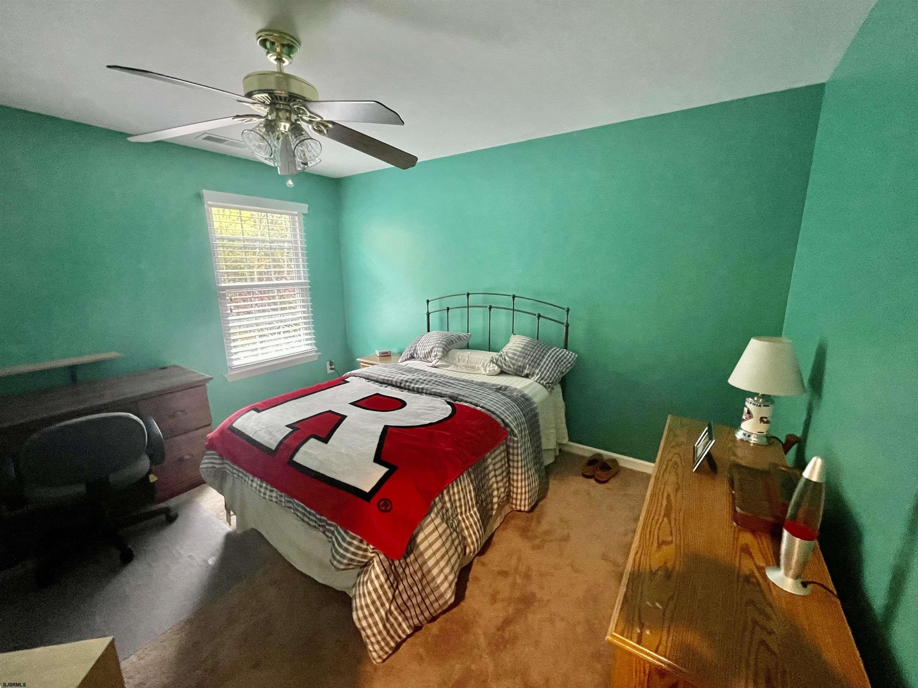 30 Cottage Road Egg Harbor Township, NJ 08234 - Photo 15 of 22 a bedroom with a bed and a chandelier