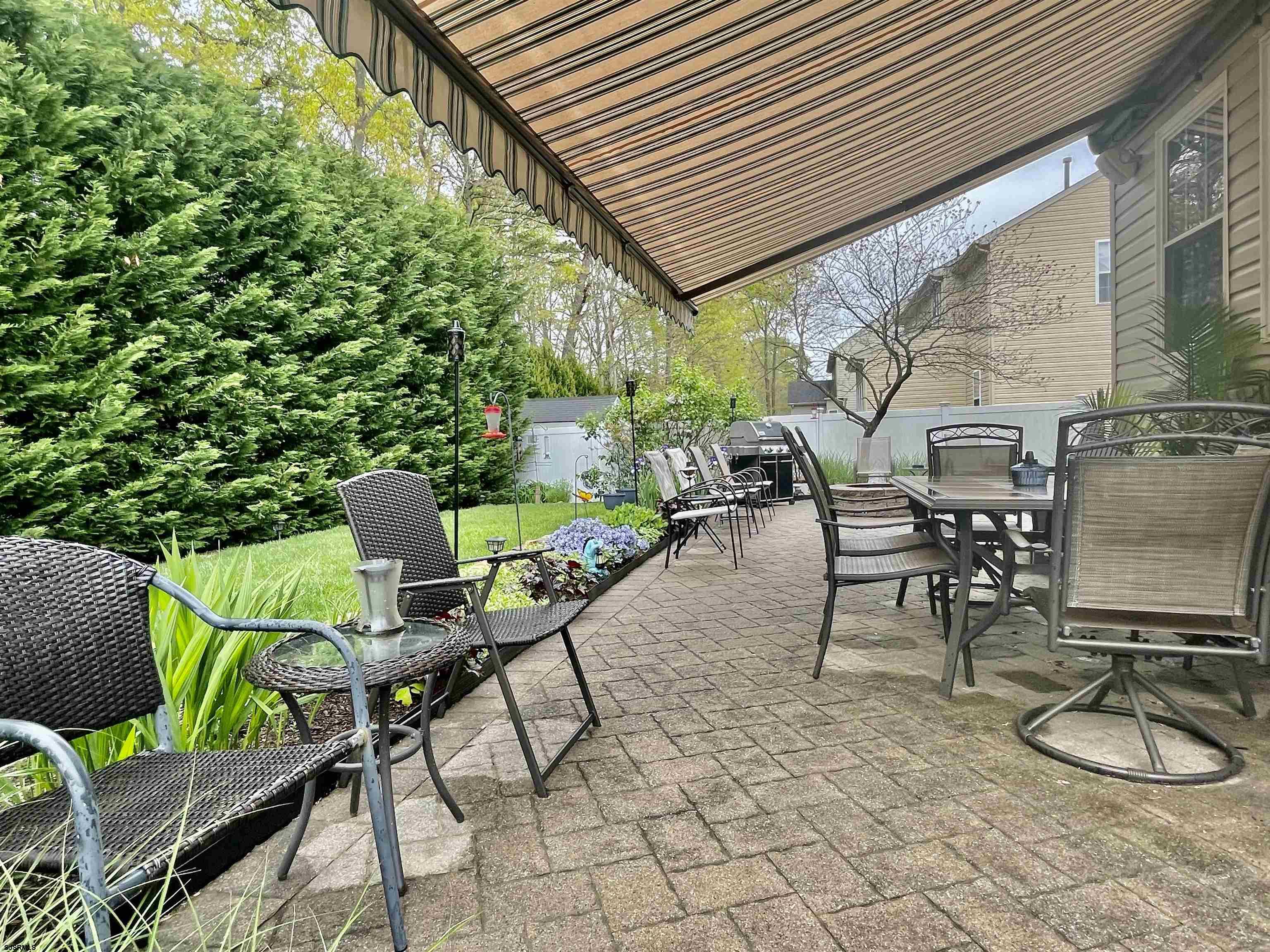 30 Cottage Road Egg Harbor Township, NJ 08234 - Photo 20 of 22 a patio with a table and chairs and potted plants