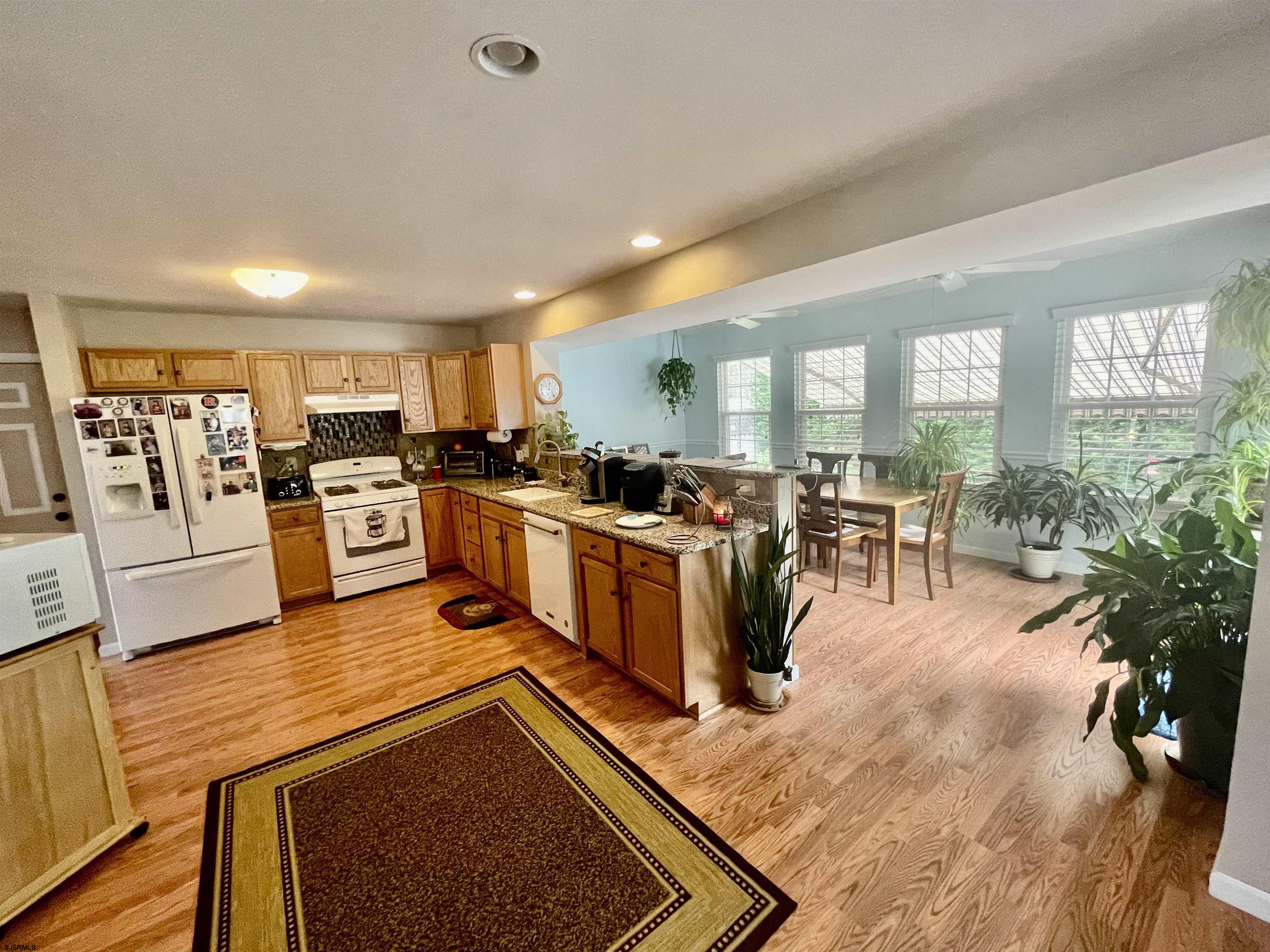 30 Cottage Road Egg Harbor Township, NJ 08234 - Photo 3 of 22 a view of a kitchen with kitchen island a large counter space stainless steel appliances and windows