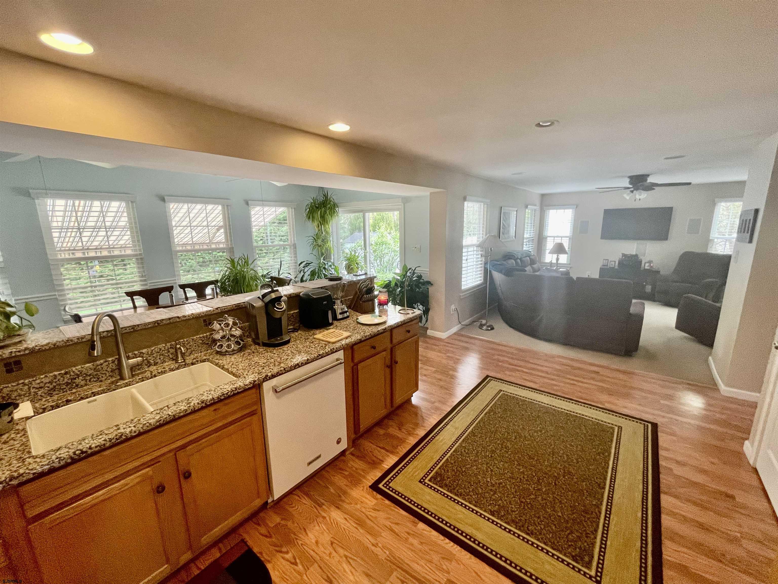 30 Cottage Road Egg Harbor Township, NJ 08234 - Photo 4 of 22 a large living room with stainless steel appliances granite countertop a couch wooden floor and a window